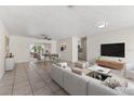 Open living room featuring tile floors, modern furnishings, and access to the dining area at 5164 Windward Ave, Sarasota, FL 34242