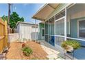 Covered back porch with an adjacent storage shed, providing convenience and functionality at 604 49Th Avenue W Dr, Bradenton, FL 34207