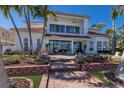Beautiful two-story home featuring a patio, pool, and well-maintained green spaces at 367 W Royal Flamingo Dr, Sarasota, FL 34236
