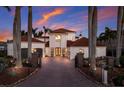 Beautiful two-story home with a red-tile roof, meticulously maintained landscaping, and brick-paved driveway at 367 W Royal Flamingo Dr, Sarasota, FL 34236