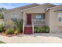 House exterior featuring red door and landscaping at 4704 Town N Country Blvd, Tampa, FL 33615