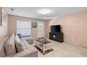 Living room with L-shaped sofa, coffee table, and TV at 4704 Town N Country Blvd, Tampa, FL 33615