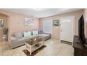 Living room featuring L-shaped sofa and coffee table at 4704 Town N Country Blvd, Tampa, FL 33615