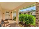 Covered porch with bench, providing a relaxing entryway at 5607 Garden Lakes Majestic, Bradenton, FL 34203