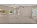 Spacious living room with high ceilings and carpet flooring at 5607 Garden Lakes Majestic, Bradenton, FL 34203