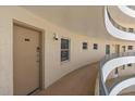 Building hallway with curved walls and railings at 6300 Midnight Pass Rd # 501, Sarasota, FL 34242