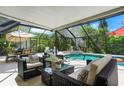 Relaxing screened pool area with seating and dining furniture at 6308 Lilac Pl, Sarasota, FL 34231