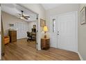 Inviting foyer with wood floors leading to an office featuring built-in closets and an adjacent doorway at 7207 Oak Moss Dr # 63, Sarasota, FL 34241