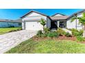 Single-story home with a white garage door and landscaped front yard at 9244 Ballaster Pointe Loop, Parrish, FL 34219