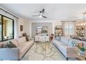 Bright living room with comfortable sofas, stylish decor, and a large window offering natural light at 10379 Medjool Dr, Venice, FL 34293