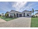 Charming one story home with a brick driveway, an attached two car garage, and well-manicured lawn at 17920 Palmiste Dr, Bradenton, FL 34202