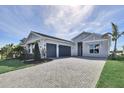 Beautiful home with a three-car garage and a paver driveway, offering ample parking and curb appeal at 17920 Palmiste Dr, Bradenton, FL 34202