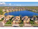 Stunning aerial view of a lakefront community with beautiful homes and lush landscaping at 21620 Avon Park Ct, Venice, FL 34293