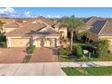 Charming home featuring a paver driveway, two-car garage, and well-maintained landscaping at 21620 Avon Park Ct, Venice, FL 34293
