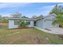 Charming one-story home features lush landscaping, a well-manicured lawn and welcoming front entrance at 2551 W Burr Oak Ct, Sarasota, FL 34232