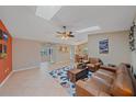 A large and sunny living room area with skylights, leather seating, and tile flooring throughout at 2551 W Burr Oak Ct, Sarasota, FL 34232