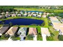 Aerial view of a charming single-Gathering home with tile roof and a well-manicured lawn in a waterfront community at 236 Golden Harbour Trl, Bradenton, FL 34212