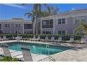 Relaxing community pool area with lounge chairs and lush landscaping around the condominium complex at 5697 Sheffield Greene Cir # 51, Sarasota, FL 34235