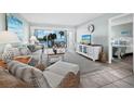 Comfortable living room features ocean views and access to a serene outdoor balcony at 605 Sutton Pl # 205, Longboat Key, FL 34228
