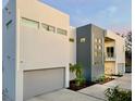 Modern two-story home with gray accents, security cameras, and a professionally landscaped front yard at 3939 Higel Ave, Sarasota, FL 34242