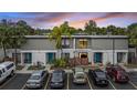 Exterior view of townhome with a bright blue front door and ample parking at 4001 Beneva Rd # 304, Sarasota, FL 34233