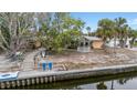 Charming single-Gathering home exterior with a gazebo, dock, and beautifully landscaped yard at 5402 Shadow Lawn Dr, Sarasota, FL 34242