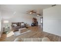 Open living room with hardwood floors, ceiling fans, and modern decor at 625 Ennis Nw Ter, Port Charlotte, FL 33952