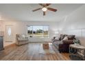 Bright living room with hardwood floors, a ceiling fan, and a large window to let in natural light at 625 Ennis Nw Ter, Port Charlotte, FL 33952