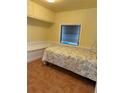 Charming single bedroom with built-in storage, wainscoting, and a cozy bed with floral bedding at 2601 Gulf N Dr # B16, Bradenton Beach, FL 34217