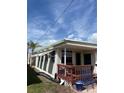 Exterior view showcasing a quaint patio and cozy outdoor seating area with a palm tree at 2601 Gulf N Dr # B16, Bradenton Beach, FL 34217