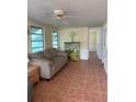 Inviting living room with a comfortable sofa, ceiling fan, and plenty of natural light at 2601 Gulf N Dr # B16, Bradenton Beach, FL 34217