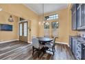 Cozy dining area with modern chandelier, wood floors, and beautiful granite counter at 603 Harbor Shore Dr, Nokomis, FL 34275