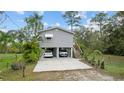 Charming stilt home with covered parking and lush tropical landscaping at 39200 Cook Brown Rd, Punta Gorda, FL 33982