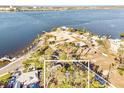 An aerial view outlines property close to the water, palms, and a nearby marina and beach at 514 Riverside E Dr, Bradenton, FL 34208