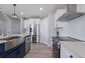 Modern kitchen featuring stainless steel appliances, white cabinets, and stylish fixtures at 15404 Trinity Fall Way, Bradenton, FL 34212