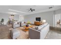 Open-concept living room with tile floors, ceiling fan, recessed lights, and neutral color palette at 452 Tierra Verde Way, Bradenton, FL 34212