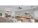 Spacious living room with tray ceiling, modern furniture, and natural light at 452 Tierra Verde Way, Bradenton, FL 34212