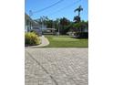 Waterfront backyard with putting green, dock, and lush landscaping at 618 Jungle Queen Way, Longboat Key, FL 34228