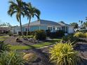 Charming waterfront home with lush landscaping and circular driveway at 618 Jungle Queen Way, Longboat Key, FL 34228