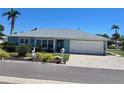 Charming waterfront home with single car garage and lush landscaping at 618 Jungle Queen Way, Longboat Key, FL 34228