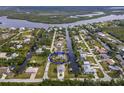 Aerial view of a waterfront home with a screened in pool that has direct canal access at 9008 Allapata Ln, Venice, FL 34293