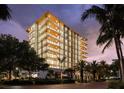 Striking exterior of the modern condo building at twilight at 111 Golden Gate Pt # 401, Sarasota, FL 34236