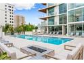Beautiful pool area with lounge chairs, cabanas and fire pit at 111 Golden Gate Pt # 401, Sarasota, FL 34236