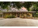 Inviting single-story home featuring lush landscaping, a screened in porch, and a spacious driveway at 2885 Arrowhead Rd, Venice, FL 34293