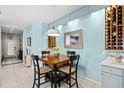 Cozy dining area with a wooden table, pendant lighting, and a view into the entryway at 3922 Wildgrass Pl, Parrish, FL 34219