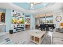 Bright and airy living room with tile flooring, a piano, and a calming coastal color palette at 3922 Wildgrass Pl, Parrish, FL 34219