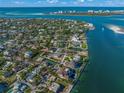 Stunning coastal home with a private tennis court, lush greenery, and panoramic ocean views at 624 Norsota Way, Sarasota, FL 34242