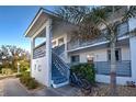 Condo exterior featuring stairway, balcony, garden, and light gray and white color scheme at 6800 Placida Rd # 2017, Englewood, FL 34224