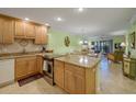 Open kitchen with granite counters, stainless steel appliances, and a view of the dining and living areas at 1801 Gulf N Dr # 175, Bradenton Beach, FL 34217