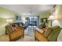 Comfortable living room featuring cozy furniture and sliding glass doors leading to the outdoors at 1801 Gulf N Dr # 175, Bradenton Beach, FL 34217
